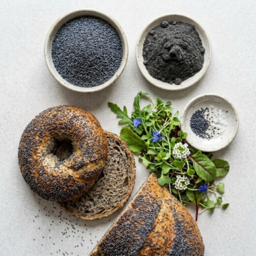 Blue poppy seeds baked into a fresh bagel showing their nutty crunch.