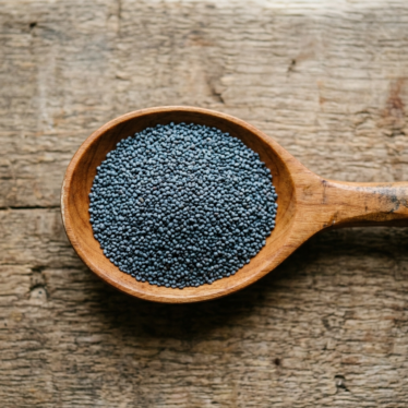 Premium blue poppy seeds displayed in a wooden spoon for culinary and nutritional use.