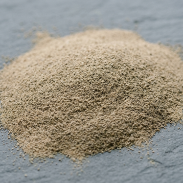 Close-up of finely ground poppy pod powder with an even, tan-to-grey color and consistent texture
