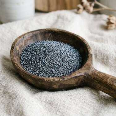 Food-grade poppy seeds resting in a wooden spoon